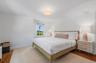 Bedroom with wood finished floors and baseboards