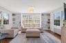Sitting room featuring wood finished floors, radiator, and built in shelves