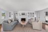 Living room with healthy amount of natural light, wood finished floors, and a fireplace
