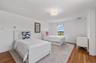 Bedroom featuring wood finished floors and baseboards