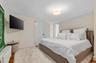 Bedroom featuring radiator and wood finished floors