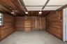 Garage with wooden walls and a garage door opener