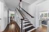 Stairway with wood-type flooring and plenty of natural light