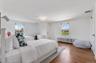 Bedroom with radiator and wood finished floors