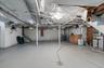 Unfinished below grade area with stairs and a water pressure tank