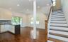 Kitchen with white cabinetry, a peninsula, decorative backsplash, recessed lighting, and open floor plan