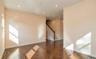 Empty room featuring recessed lighting, stairway, and dark wood-style flooring