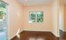Empty room featuring dark wood-style flooring and baseboards