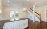Kitchen with recessed lighting, white cabinets, dark wood finished floors, open floor plan, and dark stone countertops