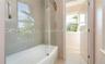 Bathroom with shower / tub combination and tile patterned flooring