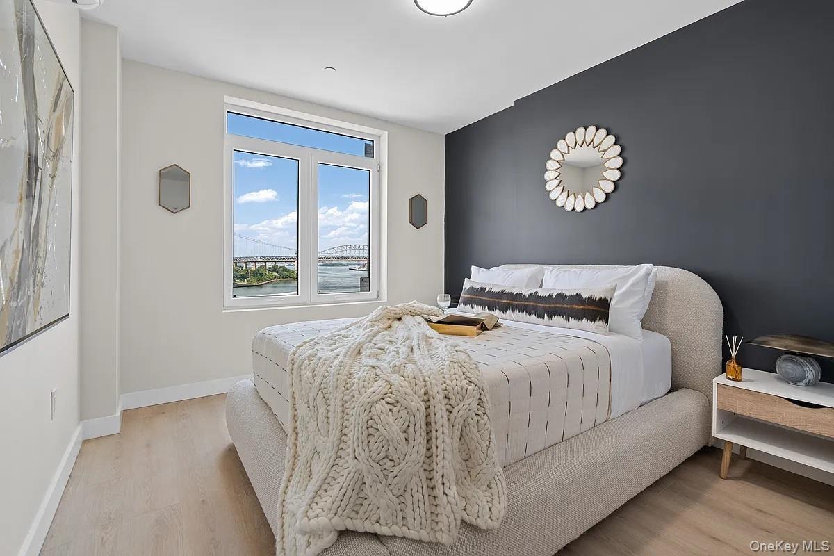 Bedroom featuring light wood-style floors and baseboards