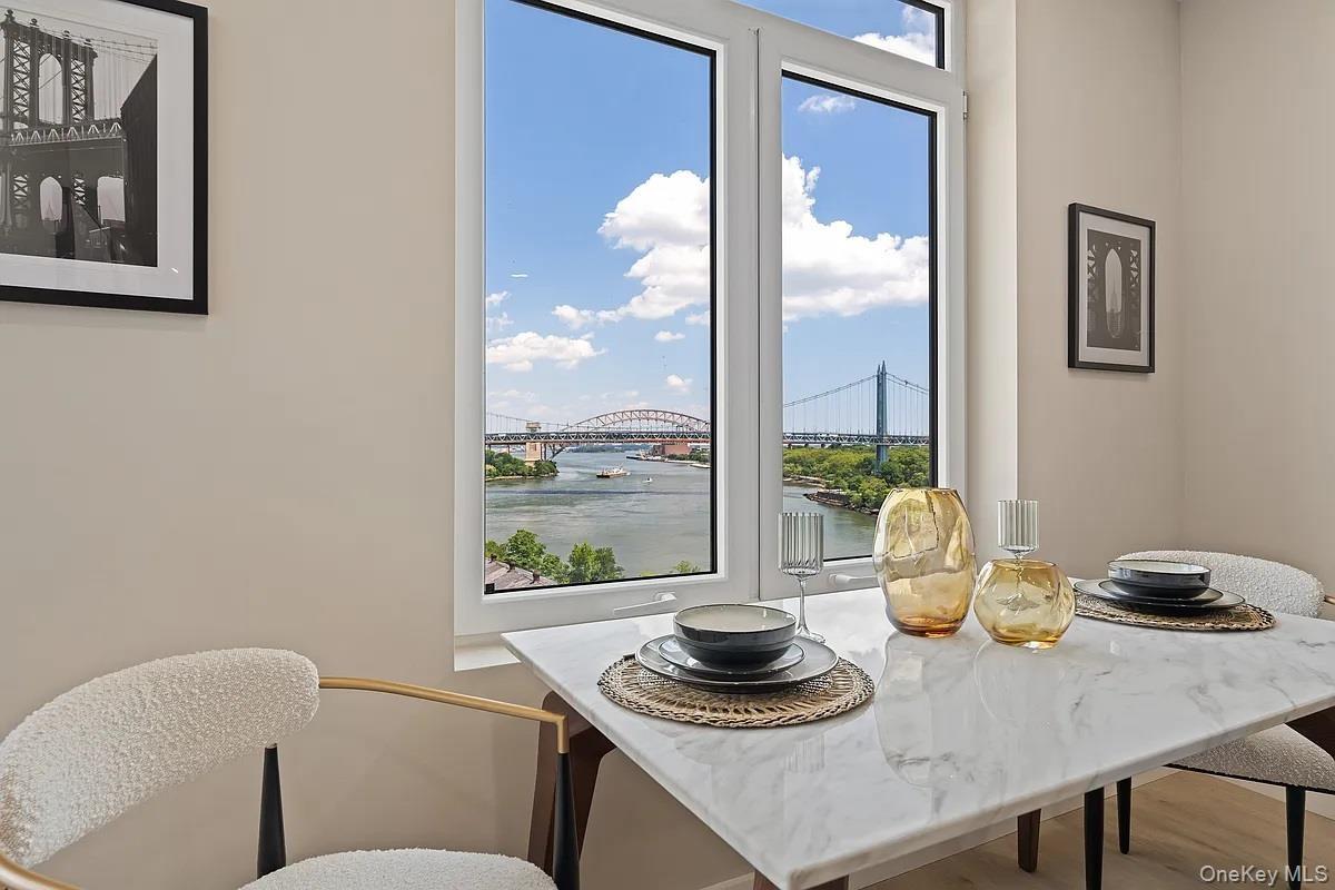 Dining area featuring a water view and wood finished floors
