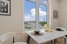 Dining area featuring a water view and wood finished floors