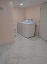 Laundry room featuring light marble finish floors and independent washer and dryer