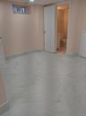 Finished basement featuring light marble finish floors