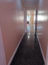 Hallway featuring granite floors and attic access