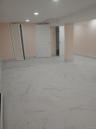 Finished basement featuring recessed lighting and light marble finish flooring