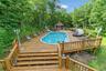 View of pool featuring a wooden deck
