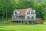 Rear view of property with a yard and a wooden deck