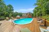 View of pool with a wooden deck
