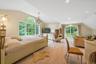 Bedroom with lofted ceiling, hardwood / wood-style floors, and a chandelier