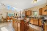 Kitchen featuring appliances with stainless steel finishes, a healthy amount of sunlight, light tile patterned floors, and a kitchen island