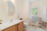 Bathroom featuring vanity, toilet, and tile patterned flooring