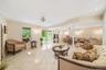 Living room featuring crown molding and light tile patterned floors
