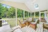 Sunroom / solarium with vaulted ceiling with skylight and ceiling fan