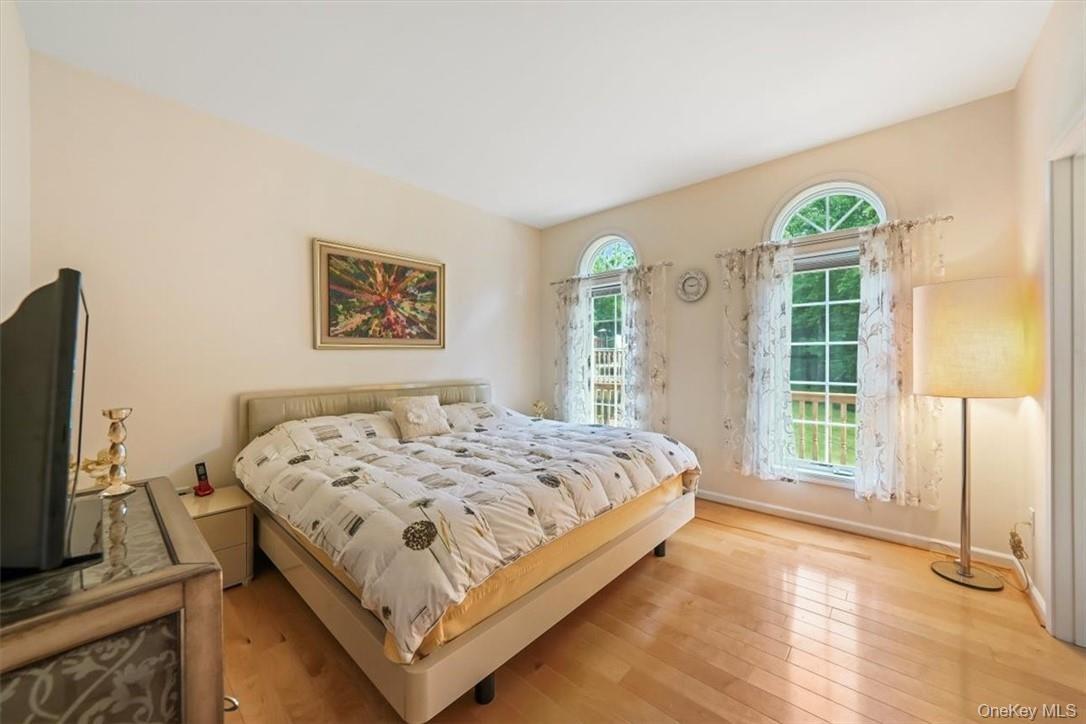 Bedroom with light hardwood / wood-style flooring