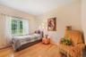 Bedroom with hardwood / wood-style flooring