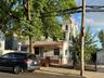 View of front of home featuring a fenced front yard and roof with shingles