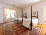 Bedroom featuring light wood-type flooring and ornamental molding