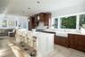 Kitchen with wood ceiling, hanging light fixtures, sink, and a center island with sink