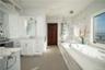Bathroom featuring vanity, shower with separate bathtub, and tile patterned flooring