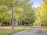 View of front of house featuring a front yard, crawl space, and brick siding