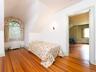 Bedroom featuring lofted ceiling, wood-type flooring, and radiator