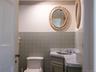 Bathroom with tile walls, vanity, and wainscoting