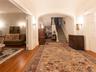 Hall featuring hardwood / wood-style flooring, stairs, arched walkways, and ornamental molding