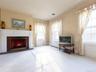 Living area featuring carpet flooring, crown molding, a fireplace, radiator, and plenty of natural light