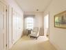 Sitting room with radiator, carpet, and crown molding