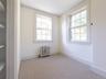Empty room featuring light colored carpet, radiator, and ornamental molding
