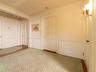 Hall featuring wainscoting, wood finished floors, and arched walkways