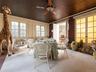 Dining area with ceiling fan and brick wall