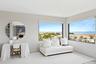Living area featuring a water view and baseboards