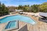 View of swimming pool featuring a pool with connected hot tub and a wooden deck