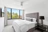 Carpeted bedroom featuring baseboards, a ceiling fan, and visible vents
