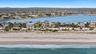 Aerial view featuring a water view and a beach view
