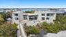 Rear view of property with a balcony and a water view