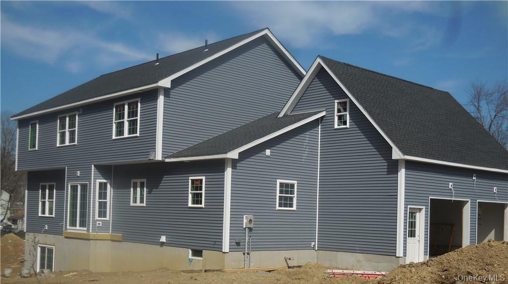 View of side of home with a garage